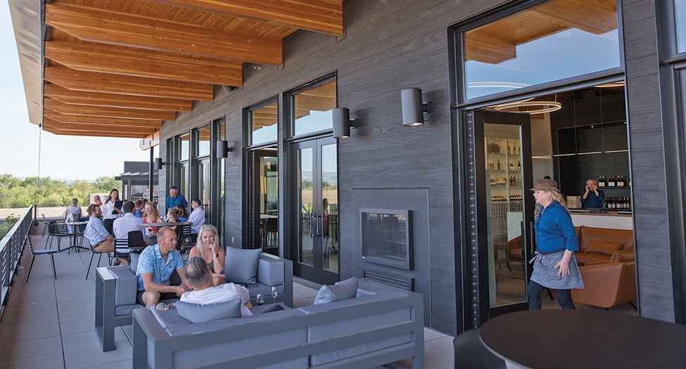 Patio at Valdemar Estates with people sitting on comfy couches drinking wine